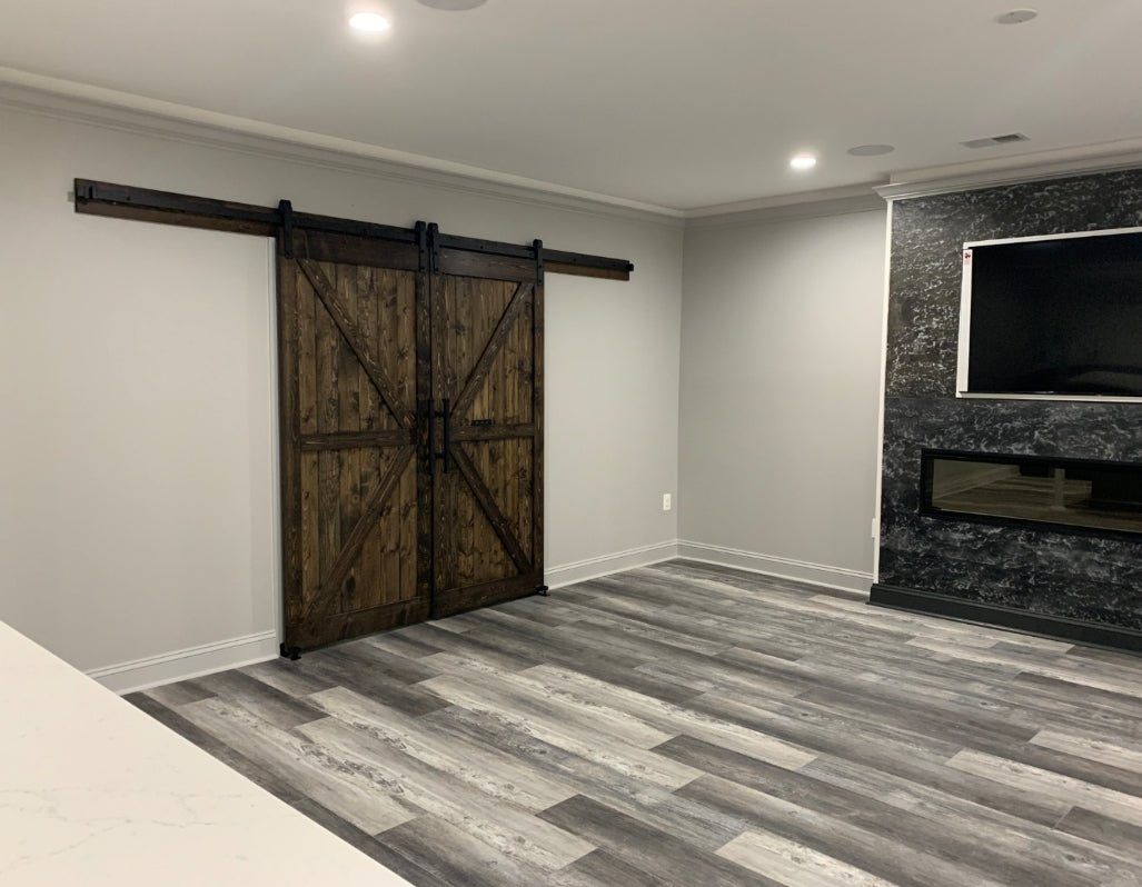 Living room featuring the Custom Double British Brace K Style Barn Door in Jacobean stain.