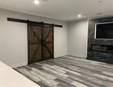 Living room featuring the Custom Double British Brace K Style Barn Door in Jacobean stain.